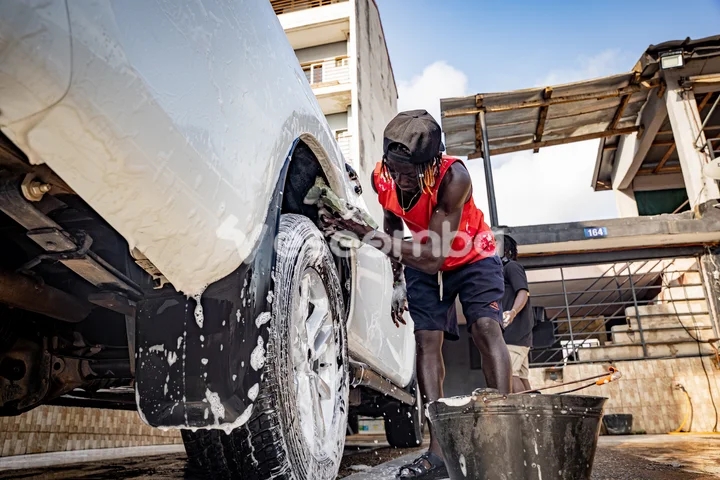 Jeune homme lavant une voiture